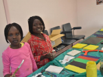 Young people during craft class building nativity cribs